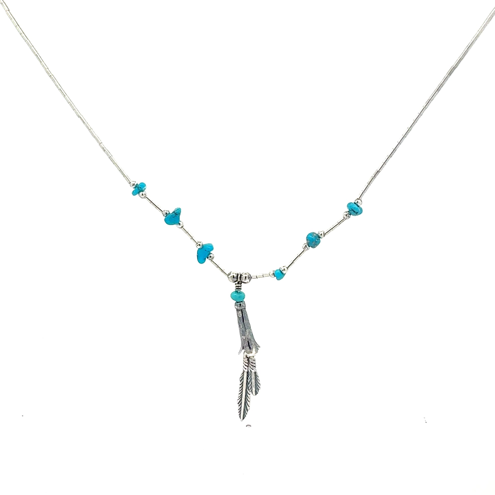 Detailansicht Federn-Anhänger mit blauen Schmucksteinen an Silberkette